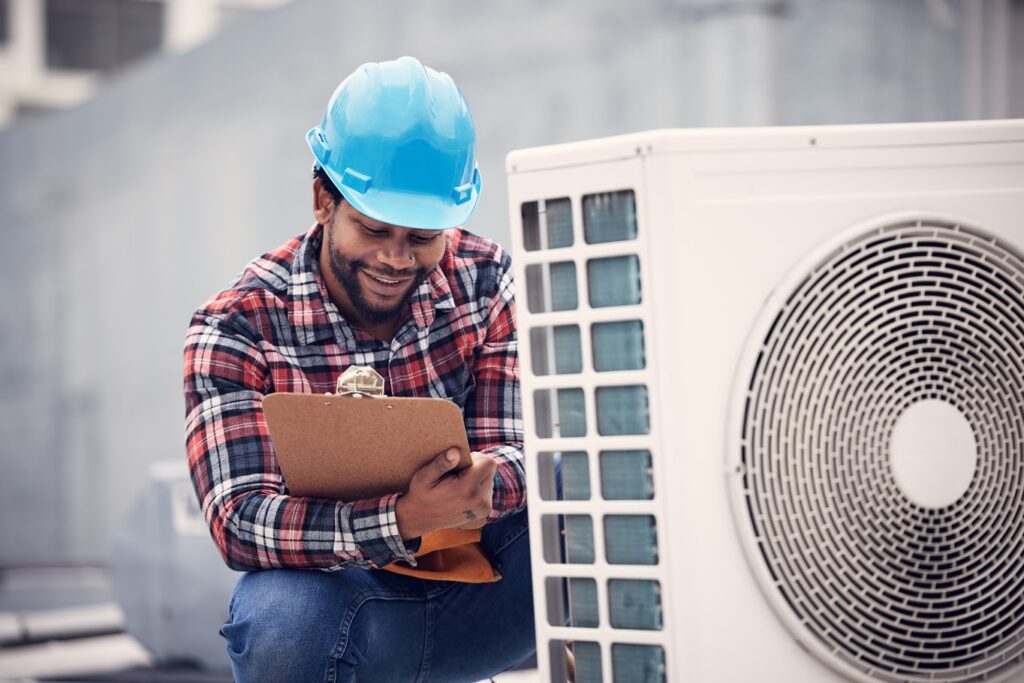Technician performing HVAC inspection on an outdoor unit.